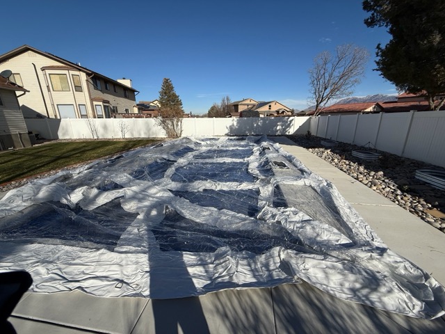 Positioning the transparent pool enclosure over swimming pool