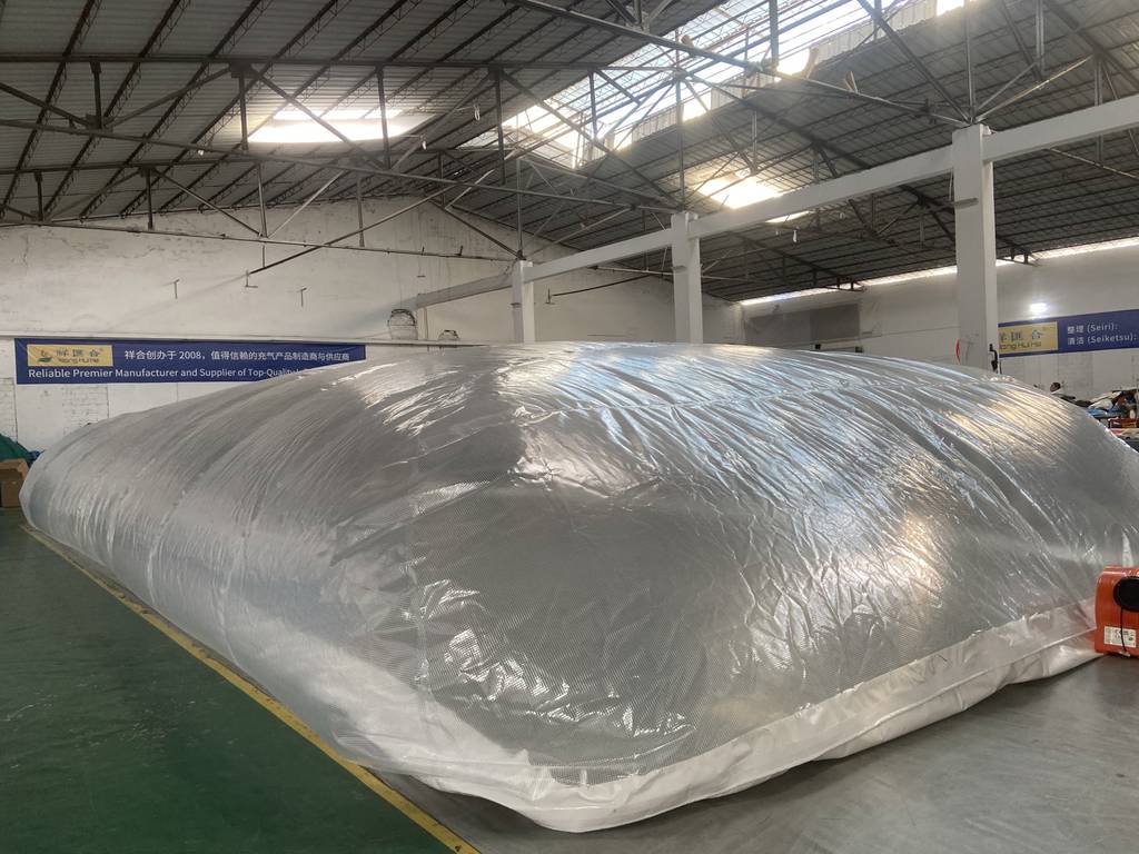 Factory technician testing an inflatable pool dome for air retention and seam strength