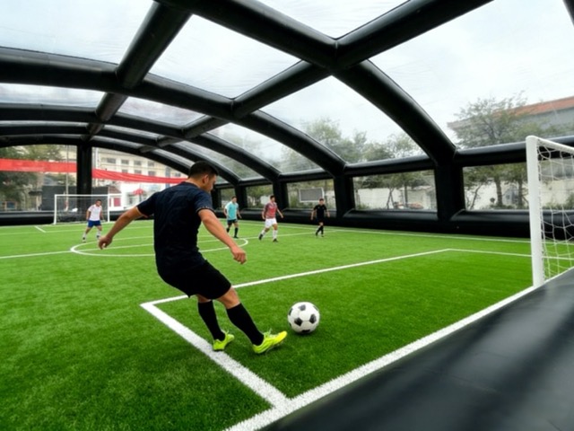 People play soccocr in the tent