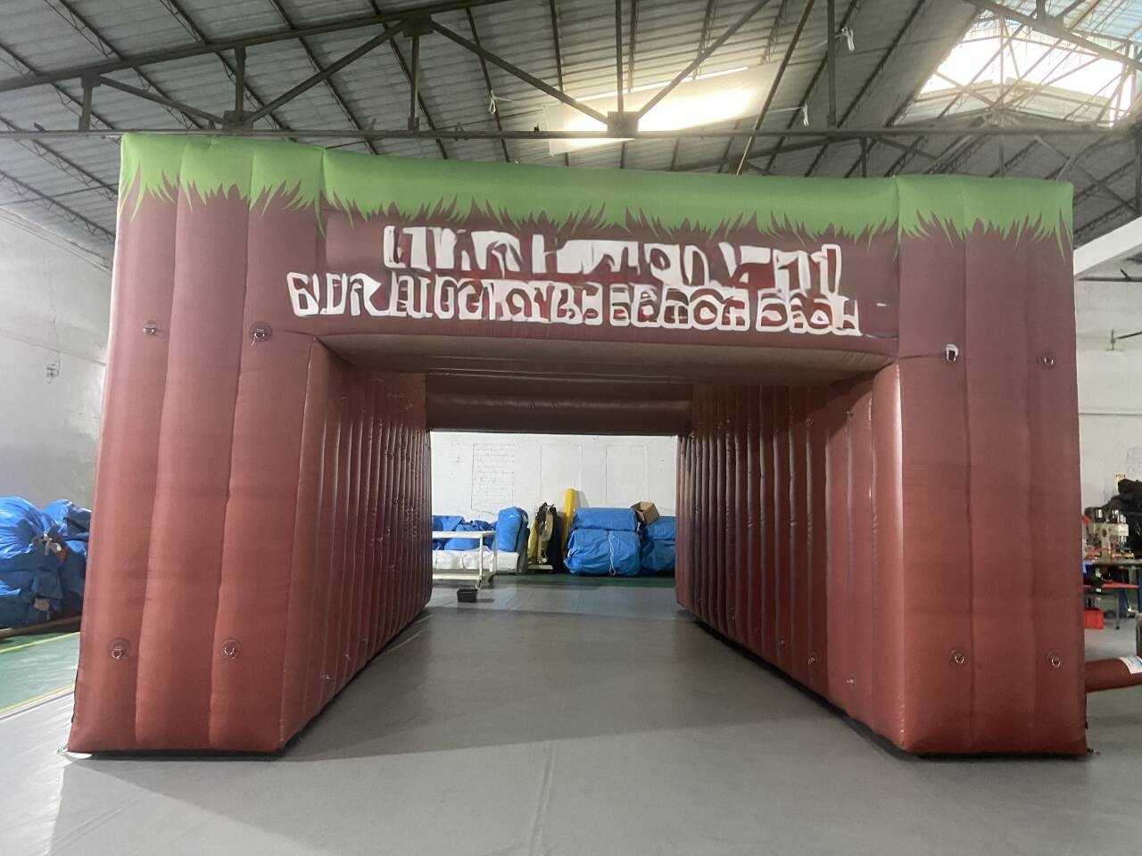 grass-top earth-tone inflatable tunnel arch